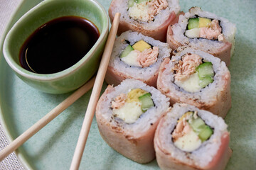 Fresh sushi rolls on a plate, top view