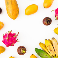 Fruits background of banana, papaya, yellow mango with mangosteen and dragon fruit on white background. Flat lay. Top view. Tropical concept