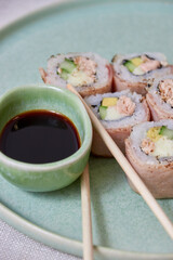 Fresh sushi rolls on a plate, top view