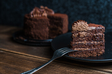 Fresh chocolate cake on wooden background