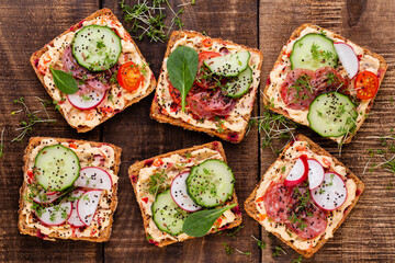 Sandwiches with cream cheese, vegetables and salami.
