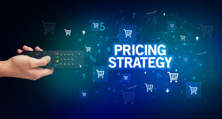 hand holding wireless peripheral with PRICING STRATEGY inscription, online shopping concept