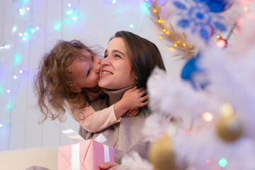 Fototapeta na wymiar Mom and daughter have fun at Christmas
