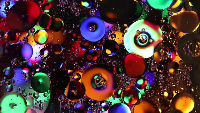 festive colorful screensaver with abstract bokeh lights. liquid bubbles moving in different direction
