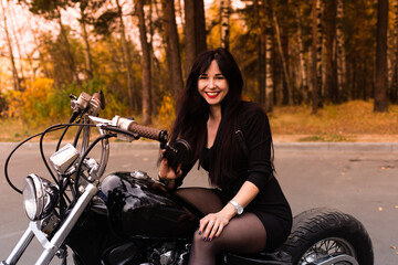 Obraz na płótnie Canvas beautiful and happy brunette on a motorcycle