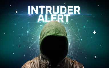 Mysterious hacker with INTRUDER ALERT inscription, online attack concept inscription, online security concept