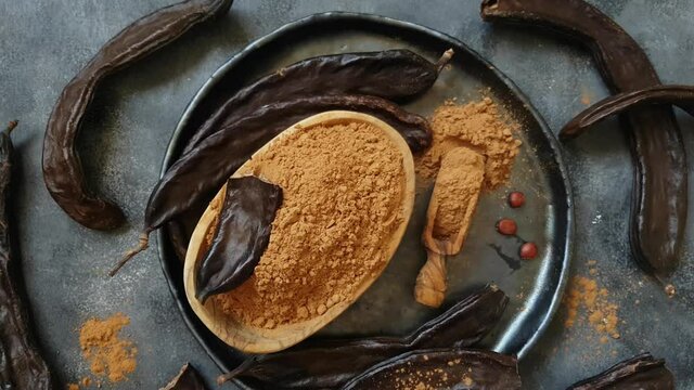 Dry carob pods and powder top view