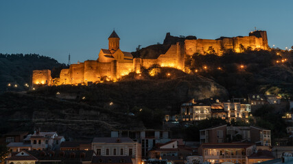 Fototapeta premium Night view of old Tbilisi. Narikala Fortress and other landmarks of the city