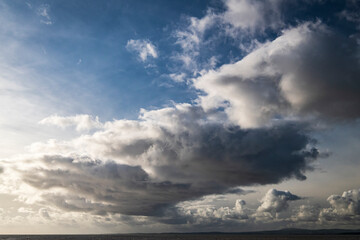 An autumnal image of a weather front over Morecambe bay, stretching from Bolton Le Sands to Walney Island, Lancashire, England