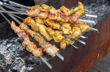 Shashlik during of cooking on the mangal over hot charcoals