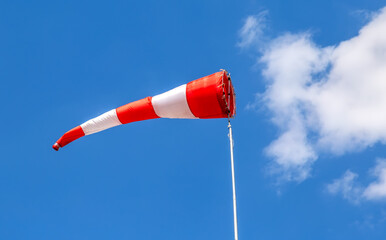 Flying windsock wind vane with red and white lines