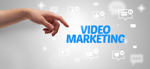 Close-Up of cropped hand pointing at VIDEO MARKETING inscription, social networking concept