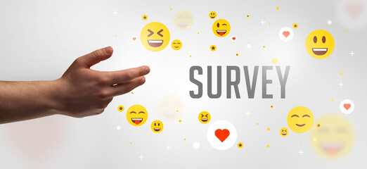 Close-Up of cropped hand pointing at SURVEY inscription, social media concept