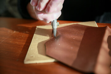 cutting a piece of leather