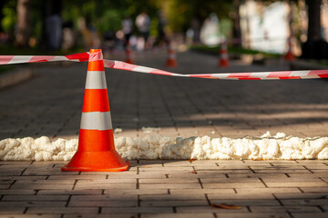 Traffic cone with red white caution tape.