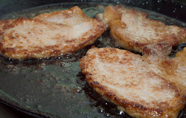 Process of cooking. Fried meat. Pork chop.