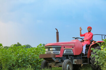 Indian farmer working with tractor at field