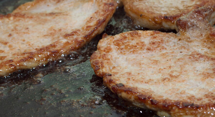 Process of cooking. Fried meat. Pork chop.