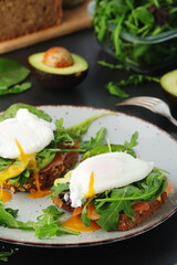 Homemade sandwiches with salmon, avocado and poached eggs