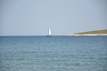 Sailing boat on Adriatic Sea defront isolated island