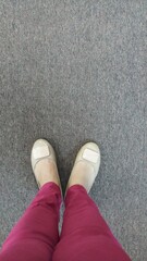 Woman with shoes standing on the floor