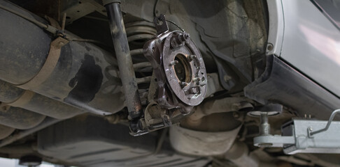 Car in service. Detail of the wheel hub assembly on automobile.
