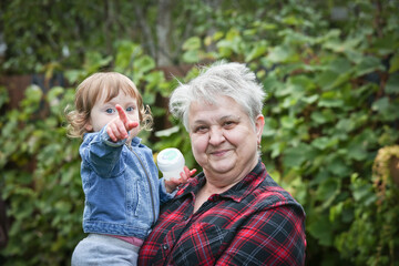 Happy Grandmother with Silver hair holding Little Cute 1 Years Old Granddaughter, October 2020, Portland, Oregon, Happy Family Concept
