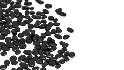 Several small black stones with a white background.
