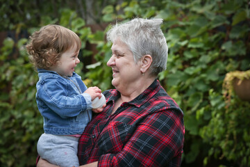 Happy Grandmother with Silver hair holding Little Cute 1 Years Old Granddaughter, October 2020, Portland, Oregon, Happy Family Concept