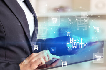 Young person makes a purchase through online shopping application with BEST QUALITY inscription