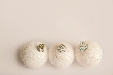 White Christmas balls on a white background close-up and copy space.