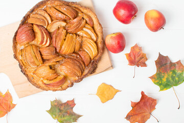 autumn apple pie on a white table