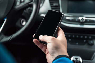 Man hold wheel and phone in a car. Driving with phone. 