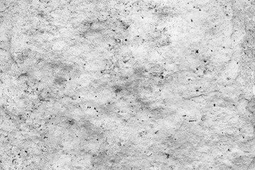 Mock up rough, uneven texture of a gray concrete wall closeup with copy space.
