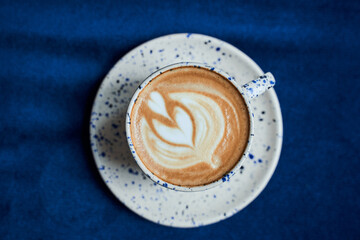 Cup with coffee standing at the tablecloth
