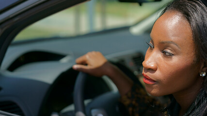 African American Woman in car smiling looking out of the window