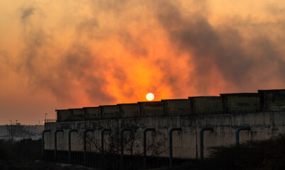 Sunset on the red Evening sky  behind the cooling tower.