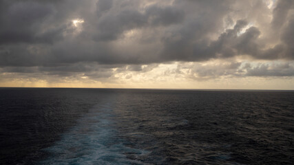 Obraz premium Dramatic cloudscapes over the open ocean at sea from Cruise ship