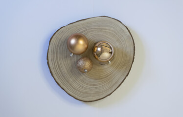 Christmas background with golden balls on wooden log