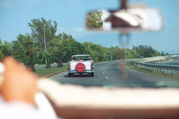 A view of a classic car taxi ride in Varadero, Cuba, looking through the windshield of a taxi, while on vacation