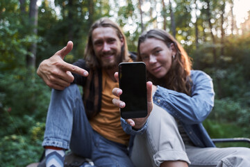 Couple showing smartphone