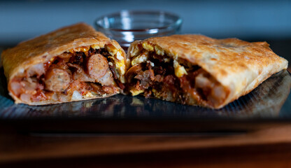 Breakfast Burrito with egg, sausage and potatoes plated on blue plate