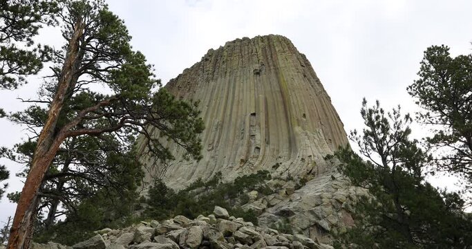 Rock climbers on Devils Tower mountain Wyoming 4K. 1,267 feet tall igneous rock tower in Black Hills of South Dakota and Wyoming. United States National Monument. Recreation, tourism, vacation.