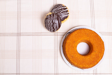 Cornmeal cake and chocolate candy in top view with space for text