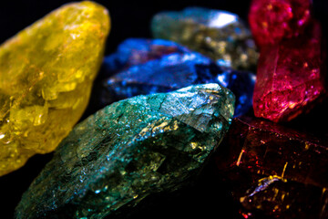 4K Assortment of glittering stones in front of black background