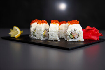 japanese sushi food. Maki ands rolls with tuna, salmon, shrimp, crab and avocado. Top view of assorted sushi. Rainbow sushi roll, uramaki, hosomaki and nigiri. Assorted sushi