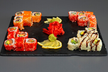 japanese sushi food. Maki ands rolls with tuna, salmon, shrimp, crab and avocado. Top view of assorted sushi. Rainbow sushi roll, uramaki, hosomaki and nigiri. Assorted sushi