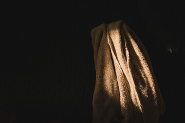 Sunlit towel on a dark background