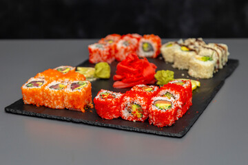japanese sushi food. Maki ands rolls with tuna, salmon, shrimp, crab and avocado. Top view of assorted sushi. Rainbow sushi roll, uramaki, hosomaki and nigiri. Assorted sushi