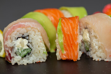 japanese sushi food. Maki ands rolls with tuna, salmon, shrimp, crab and avocado. Top view of assorted sushi. Rainbow sushi roll, uramaki, hosomaki and nigiri. Assorted sushi